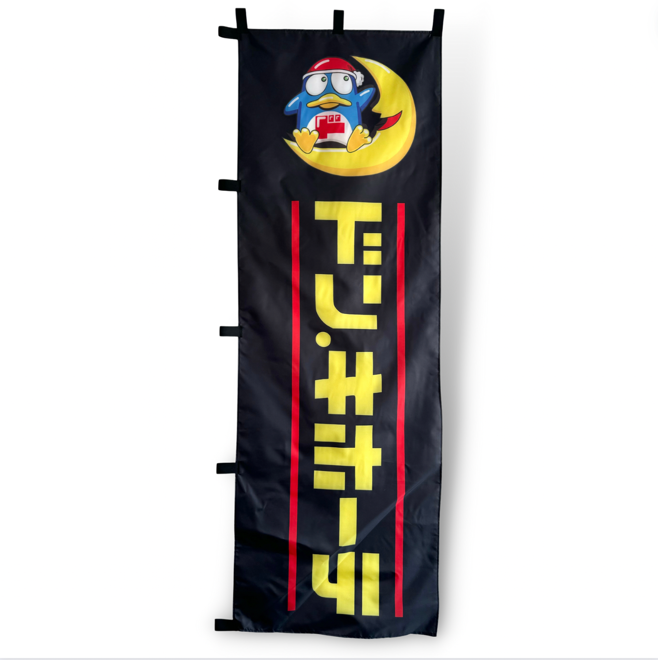 A rectangular flag with a cartoon character and Japanese text Don Quijote Nobori , predominantly black with red and yellow accents.