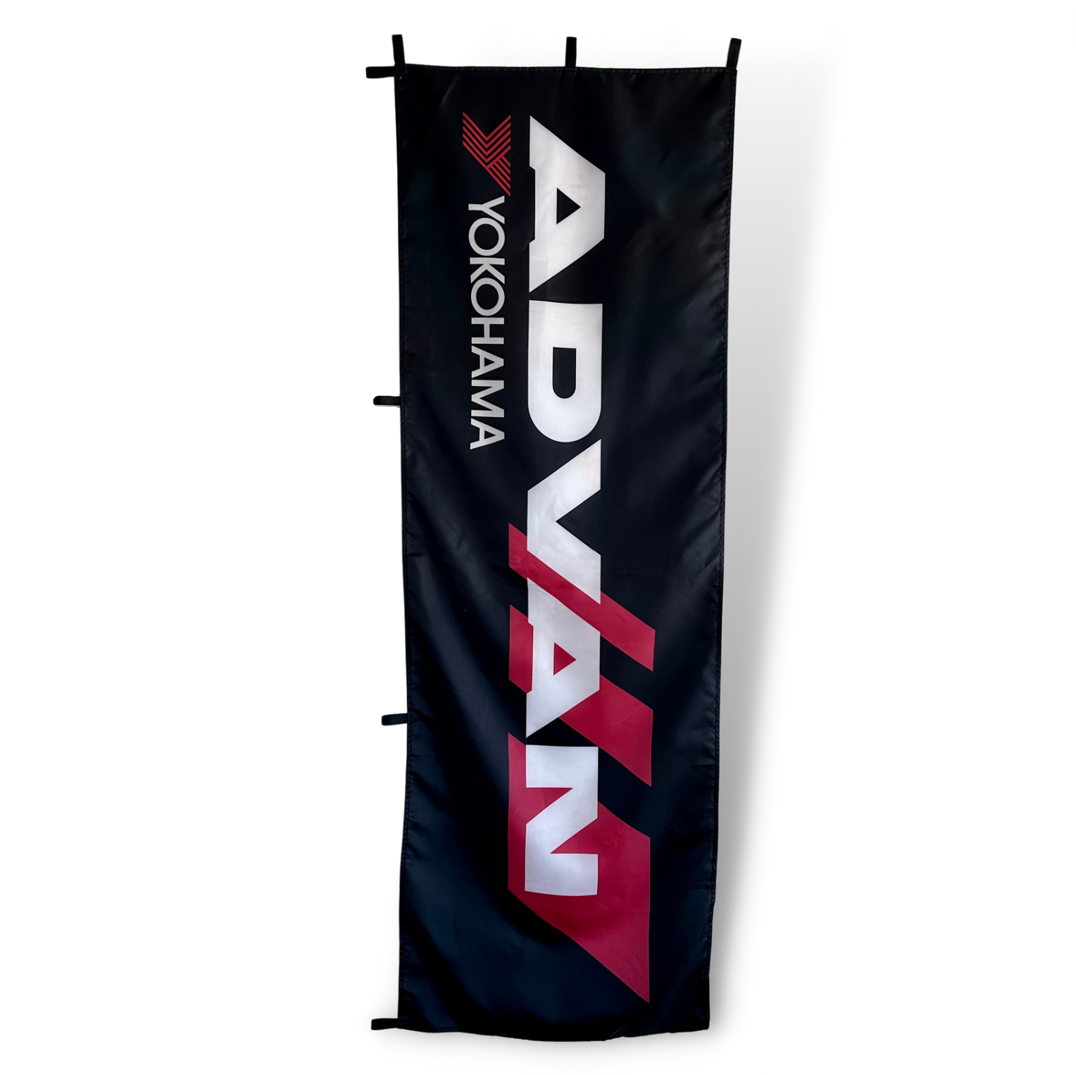 A vertical flag featuring the Advan Yokohama brand logo with the brand name in red and white on a black background.