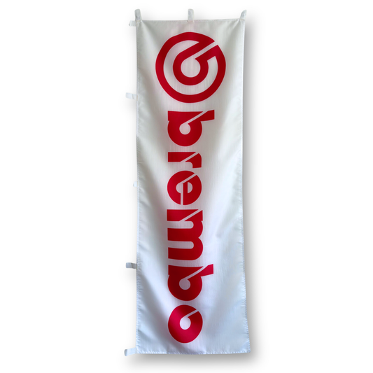 A rectangular flag with a white background featuring the red Brembo logo.