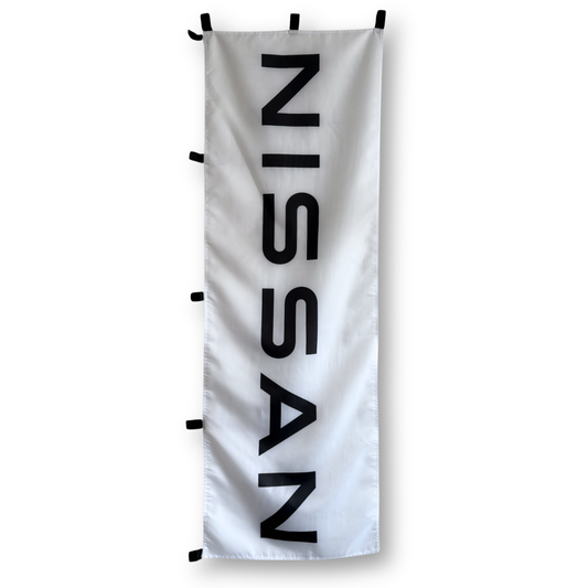 A white rectangular flag with the black text 'NISSAN' displayed in the center.