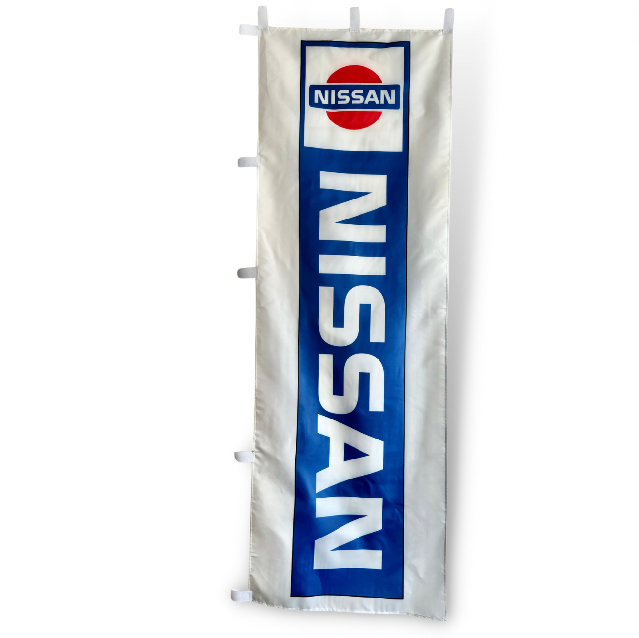 A rectangular Nissan flag featuring the company's logo in blue and white colors with a visible brand name.